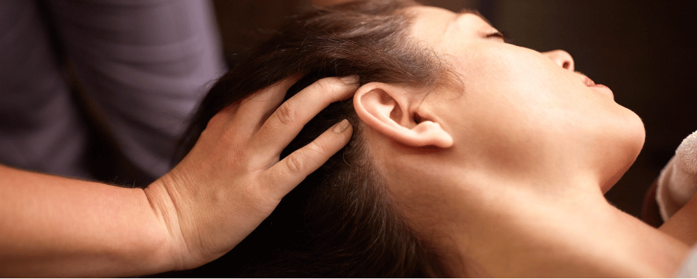 Client receiving a relaxing Indian head massage at re:new Hair & Beauty in Woodhall Spa