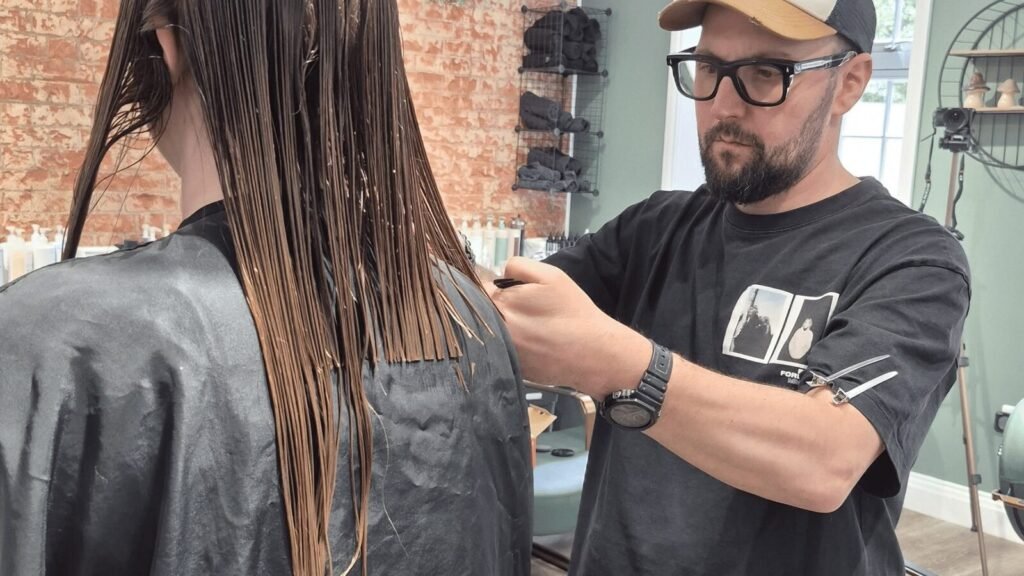 Davide Spinelli demonstrating a professional hair-cutting technique at re:new Hair & Beauty in Woodhall Spa