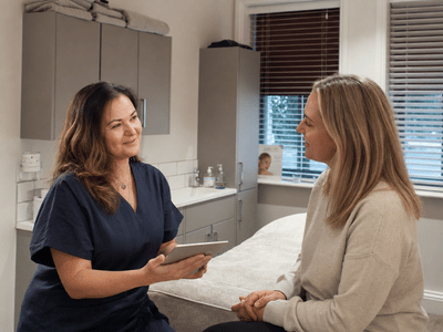 Amy discussing a beauty treatment with a client at re:new Hair & Beauty in Woodhall Spa