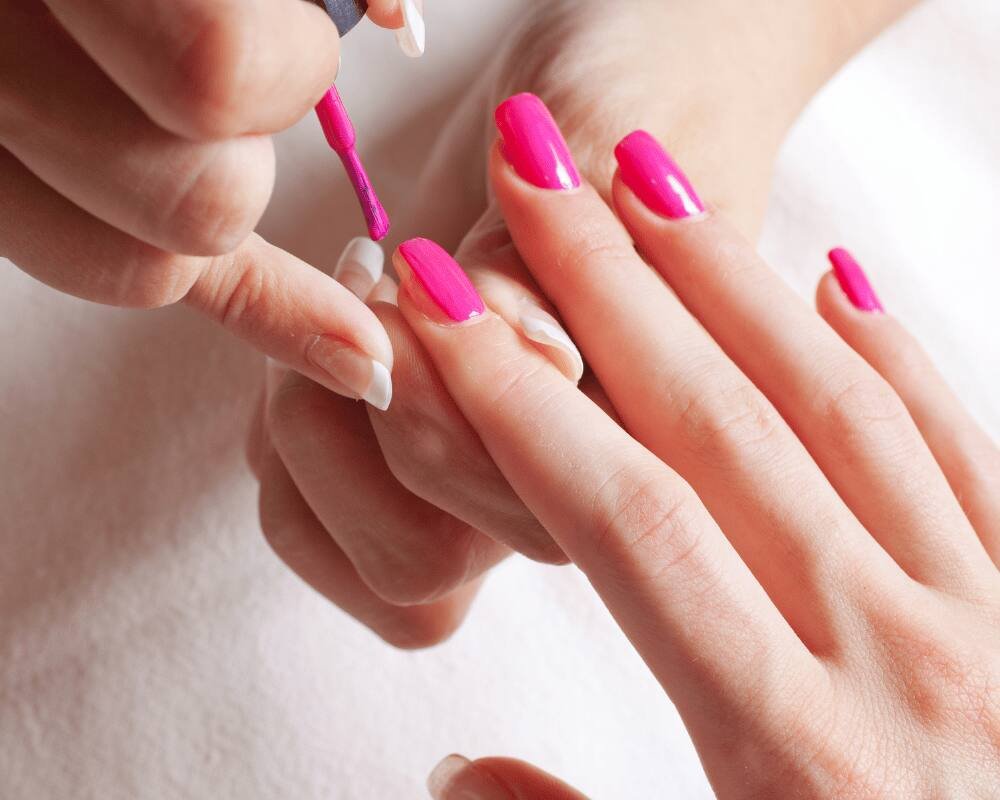 Bright pink OPI gel polish being applied during a manicure at re:new Hair & Beauty in Woodhall Spa