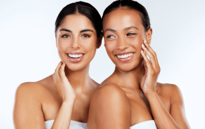 Two happy women with healthy, radiant-looking skin representing the Radiant Skin for Life Club at re:new Woodhall Spa