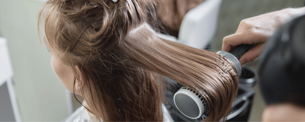 Stylist creating a smooth professional blow-dry at re:new salon in Woodhall Spa