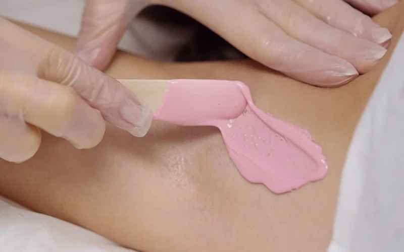 Pink Lycon hot wax being applied during a professional waxing treatment at re:new Woodhall Spa