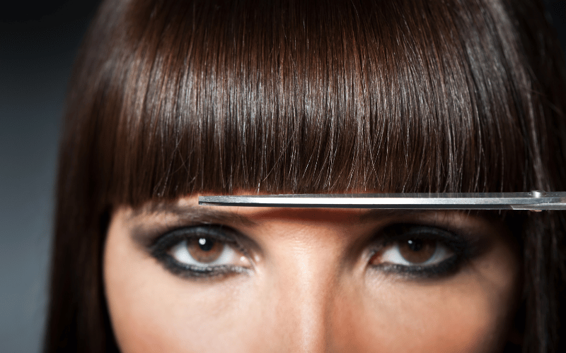 Precision cutting a straight brunette fringe at re:new salon in Woodhall Spa
