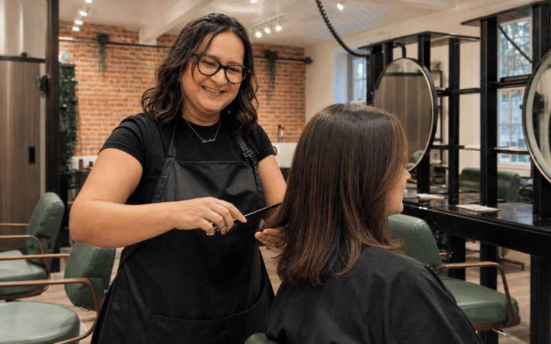 Hair stylist Anisha precision cutting a client’s hair at re:new salon in Woodhall Spa