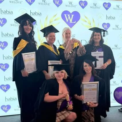 Wendy, Laurie, Demi, Jade and Anisha of re:new in caps and gowns at the WELOVE Purple Hearts Graduation